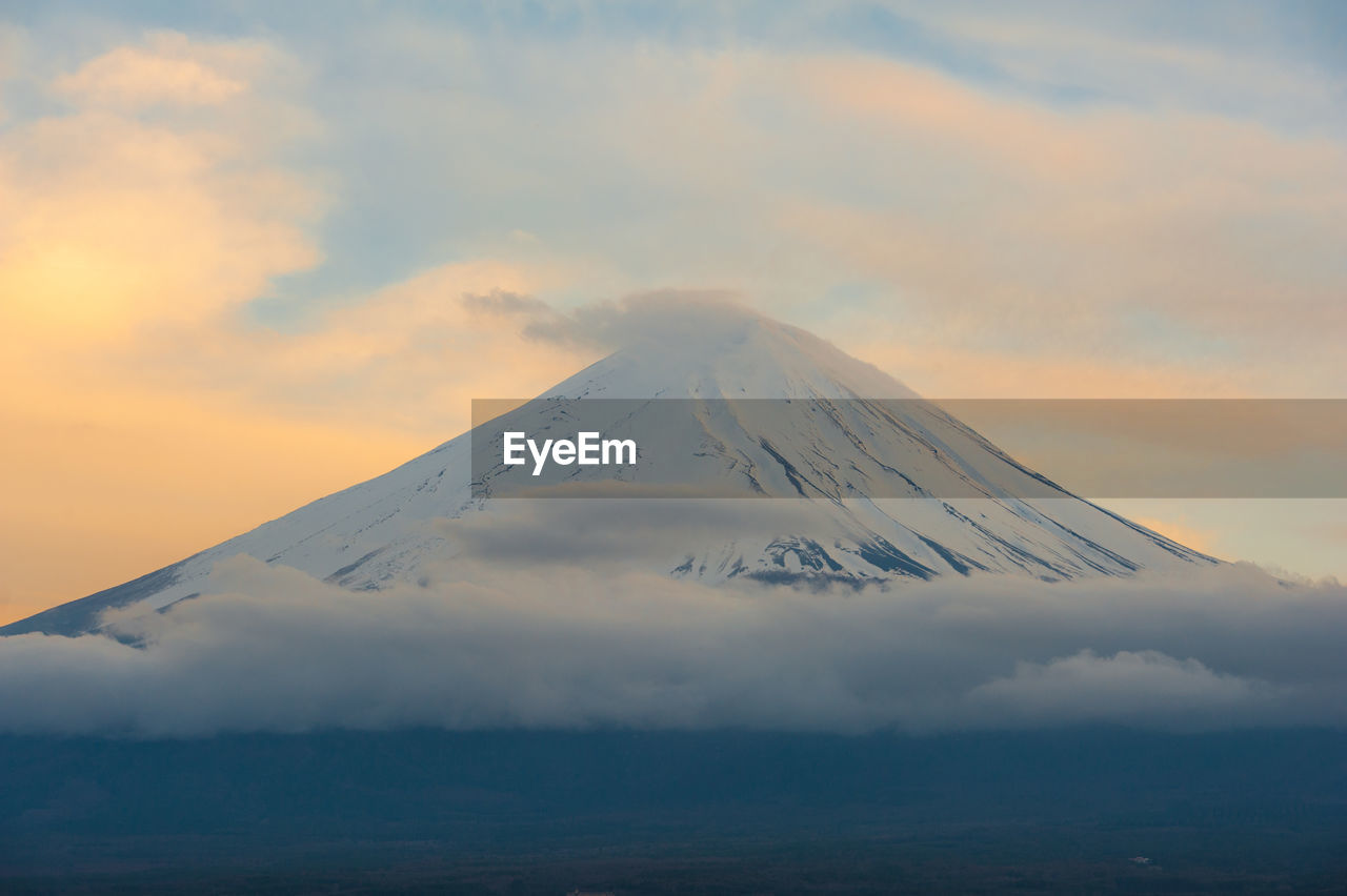 Scenic view of snowcapped mountains against sky during sunset