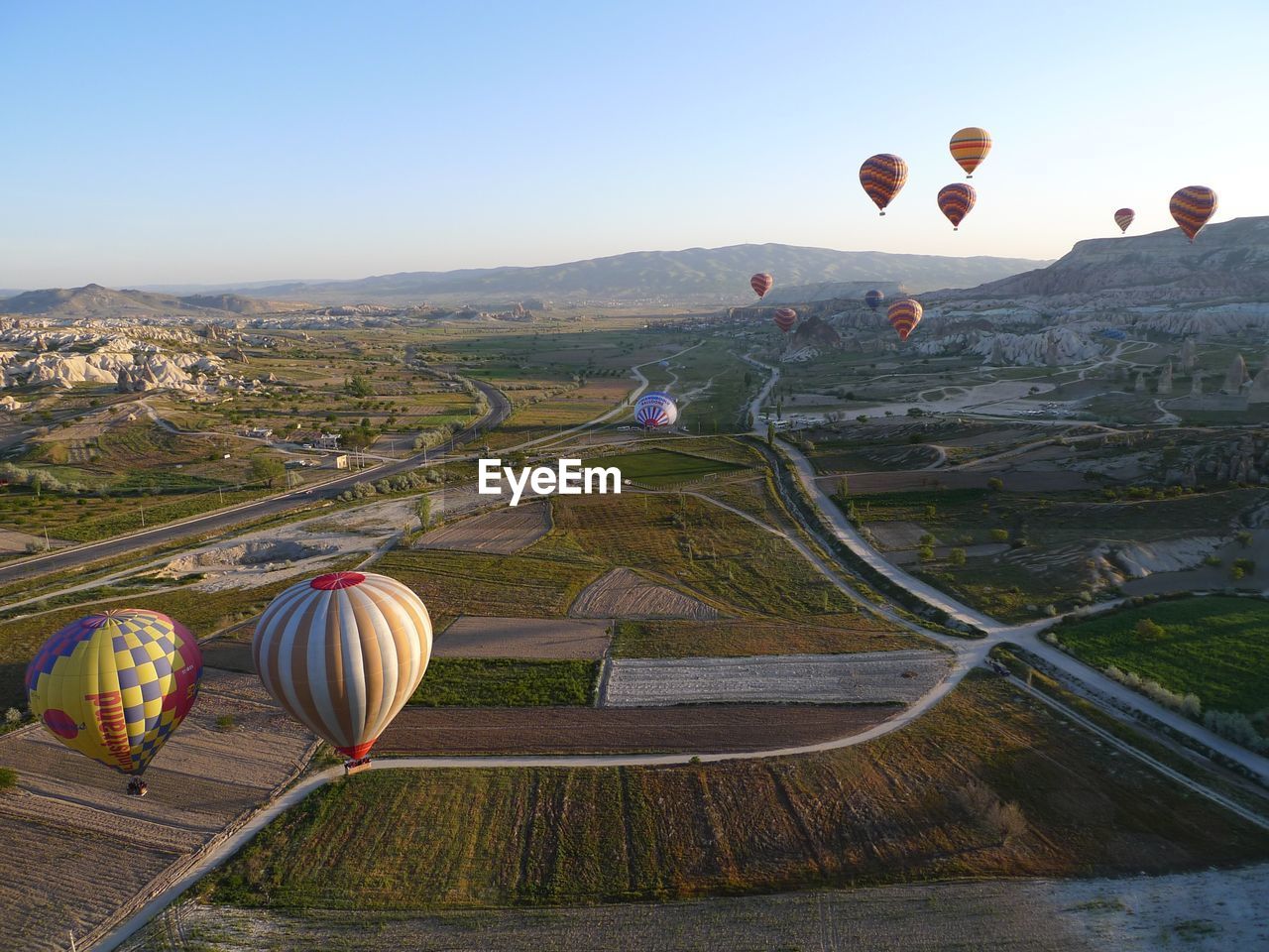 HOT AIR BALLOONS FLYING OVER LAND
