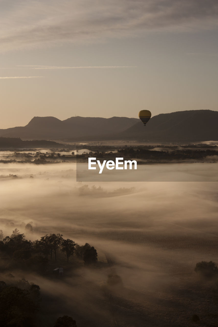 Hot air balloons against sky during sunset