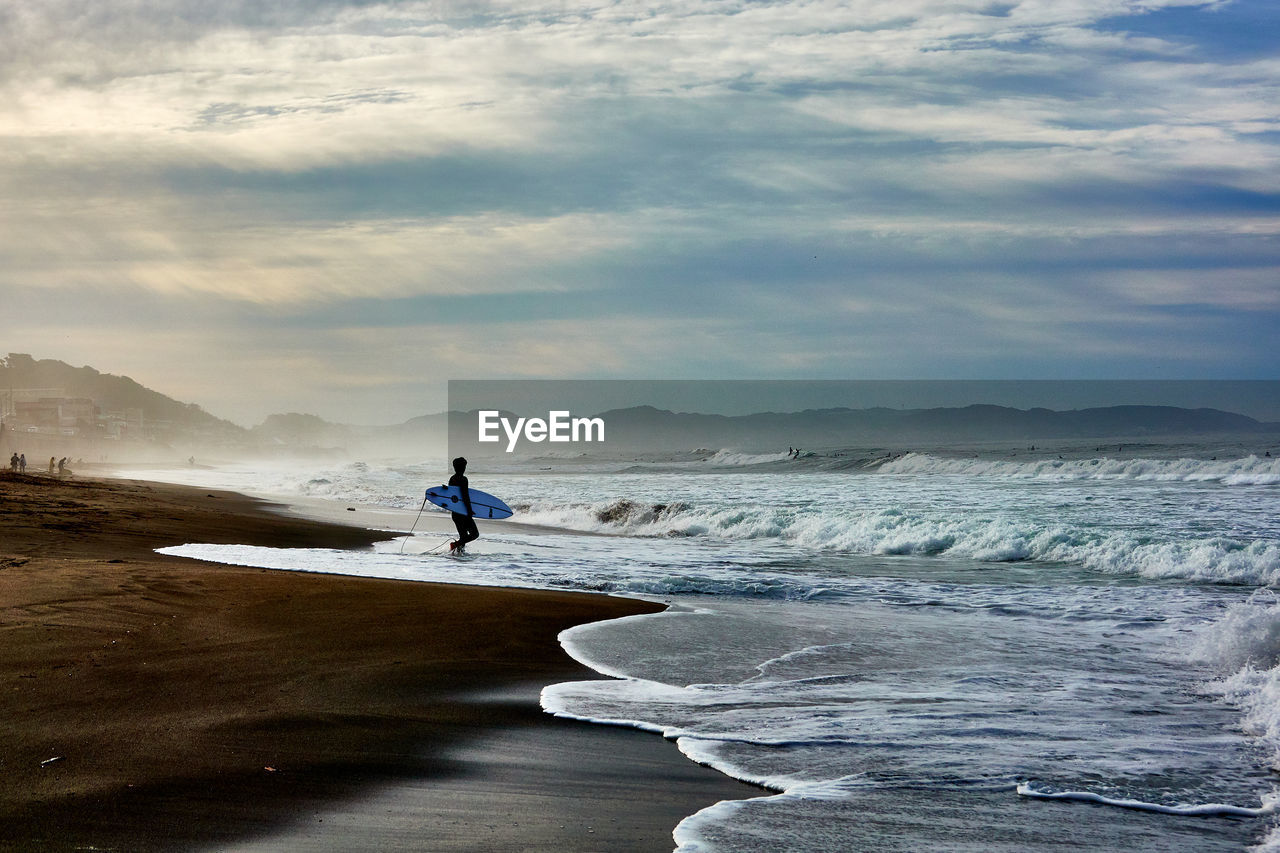 Man on beach against sky