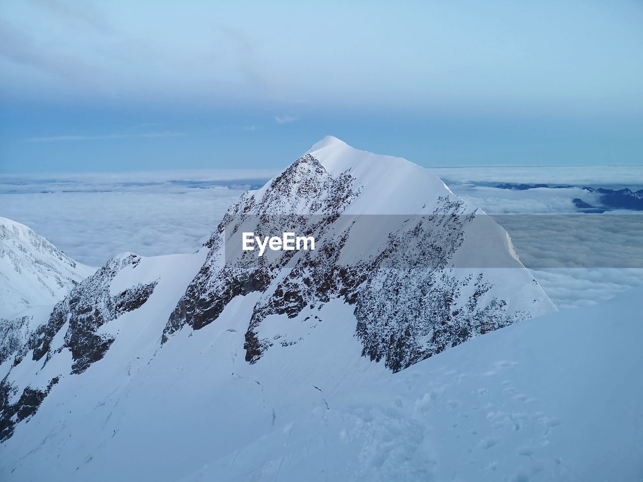 SNOW COVERED LANDSCAPE AGAINST SKY