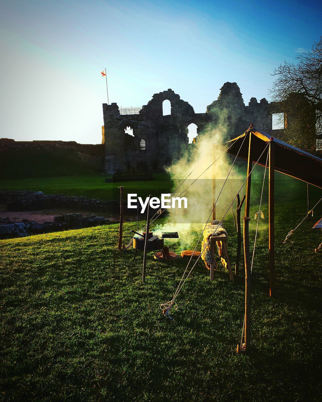 Smoke by tent at tutbury castle against sky