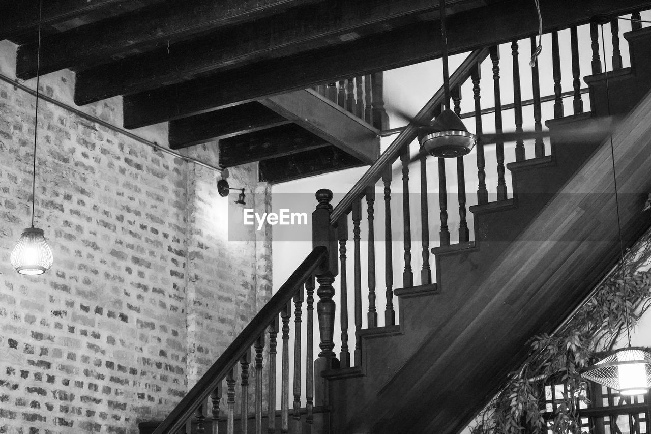 architecture, built structure, staircase, railing, steps and staircases, black, stairs, black and white, monochrome, low angle view, monochrome photography, white, no people, light, building exterior, darkness, lighting equipment, building, outdoors