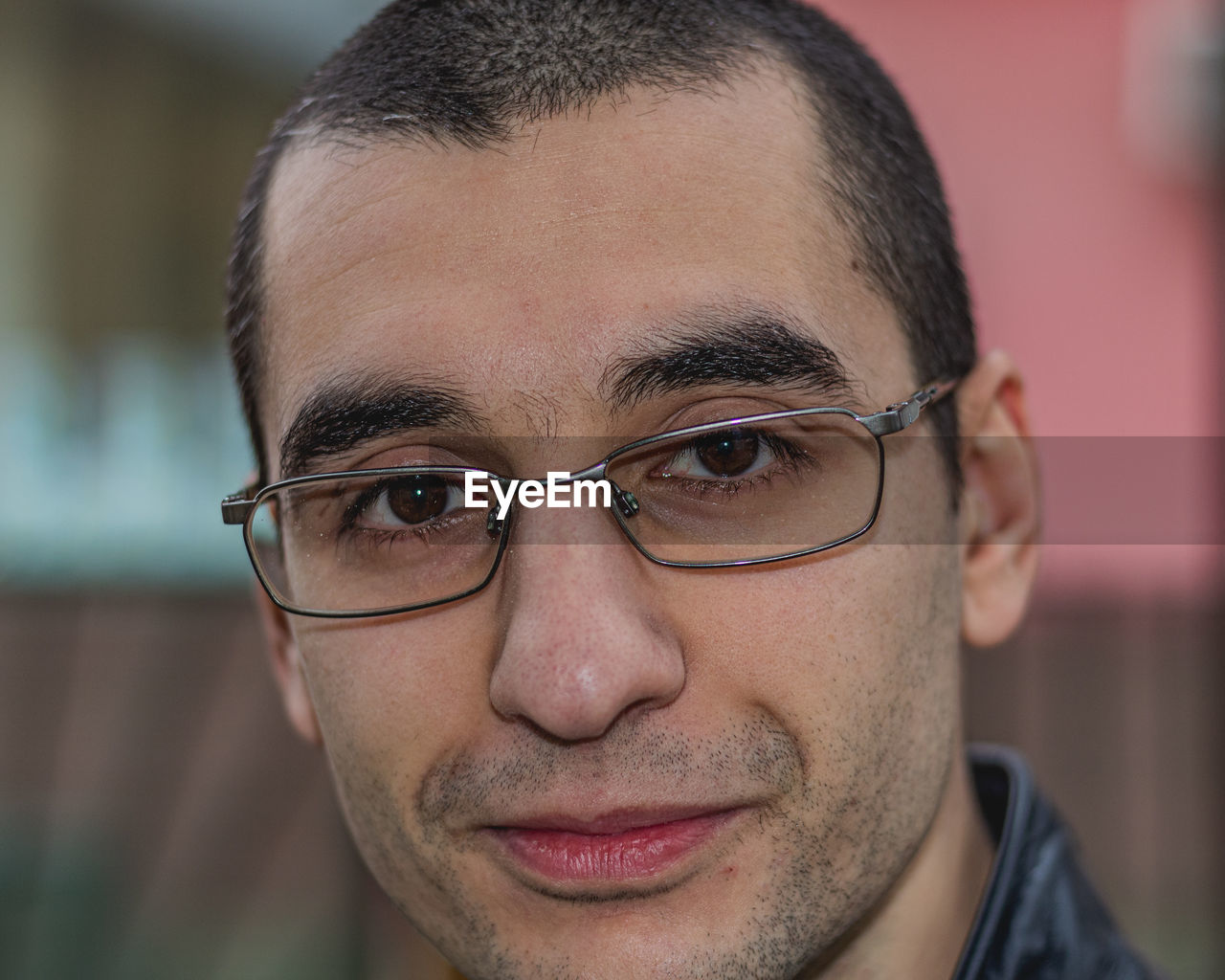 Close-up portrait of young man in eyeglasses