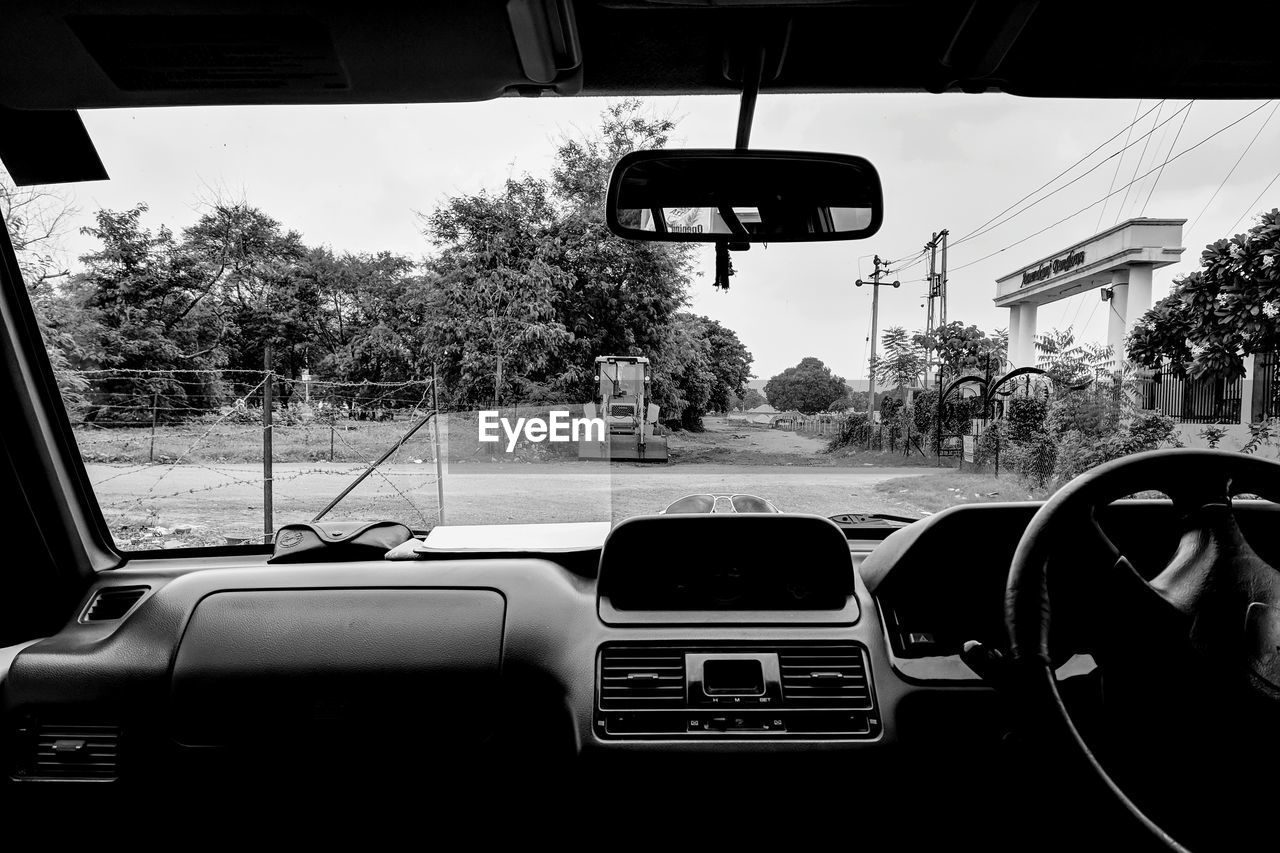 CAR ON ROAD SEEN THROUGH GLASS