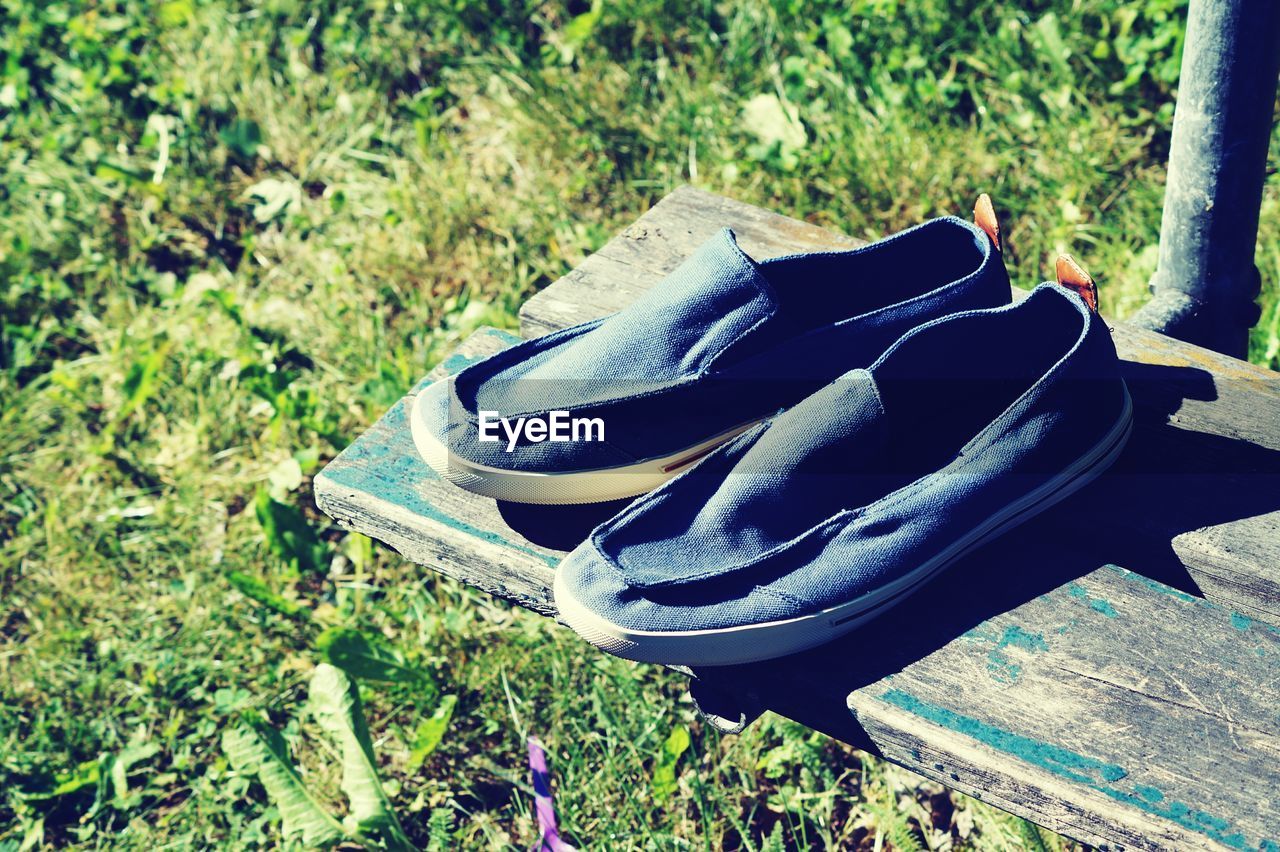 Close-up of shoes on plank