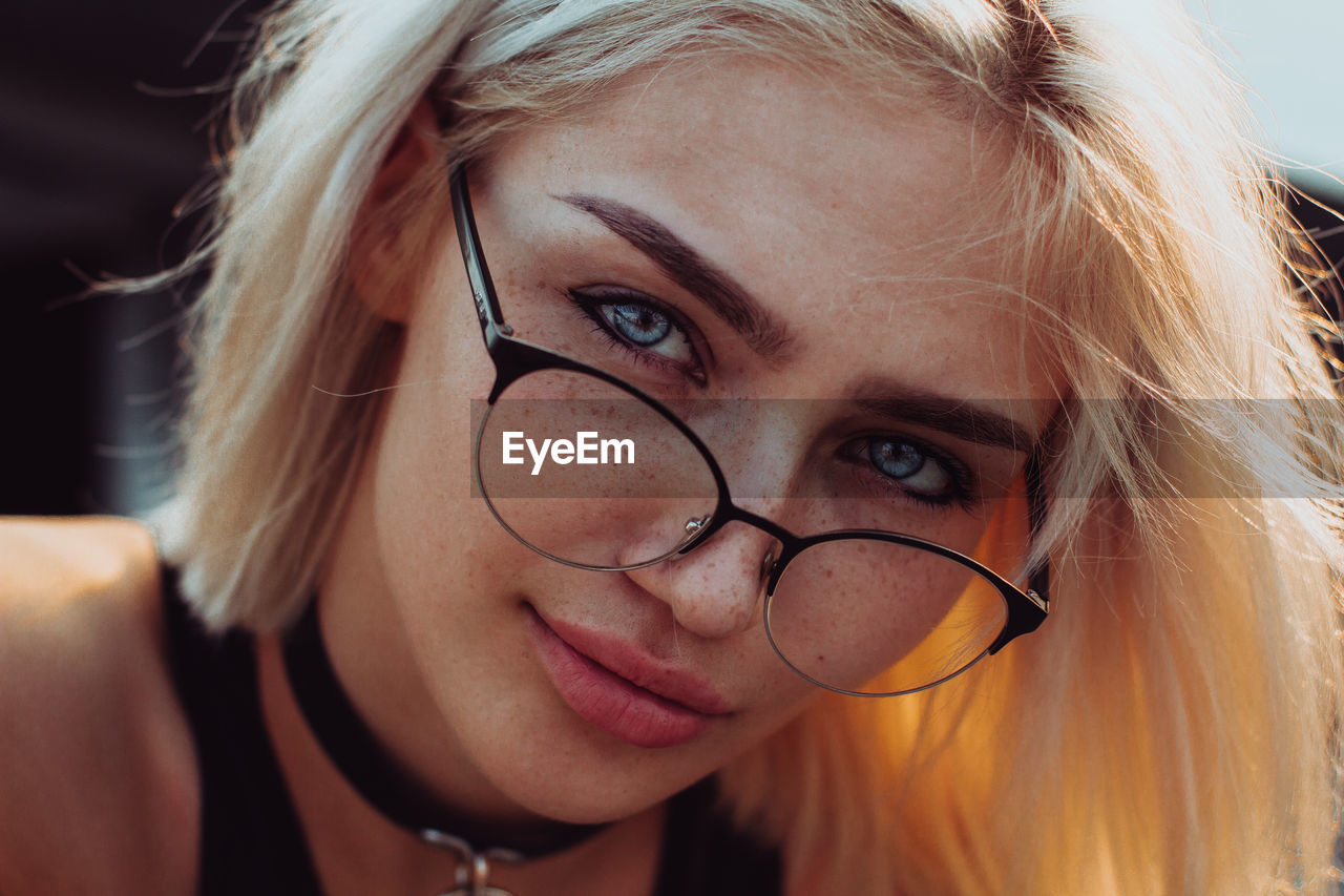 Close-up portrait of woman wearing eyeglasses