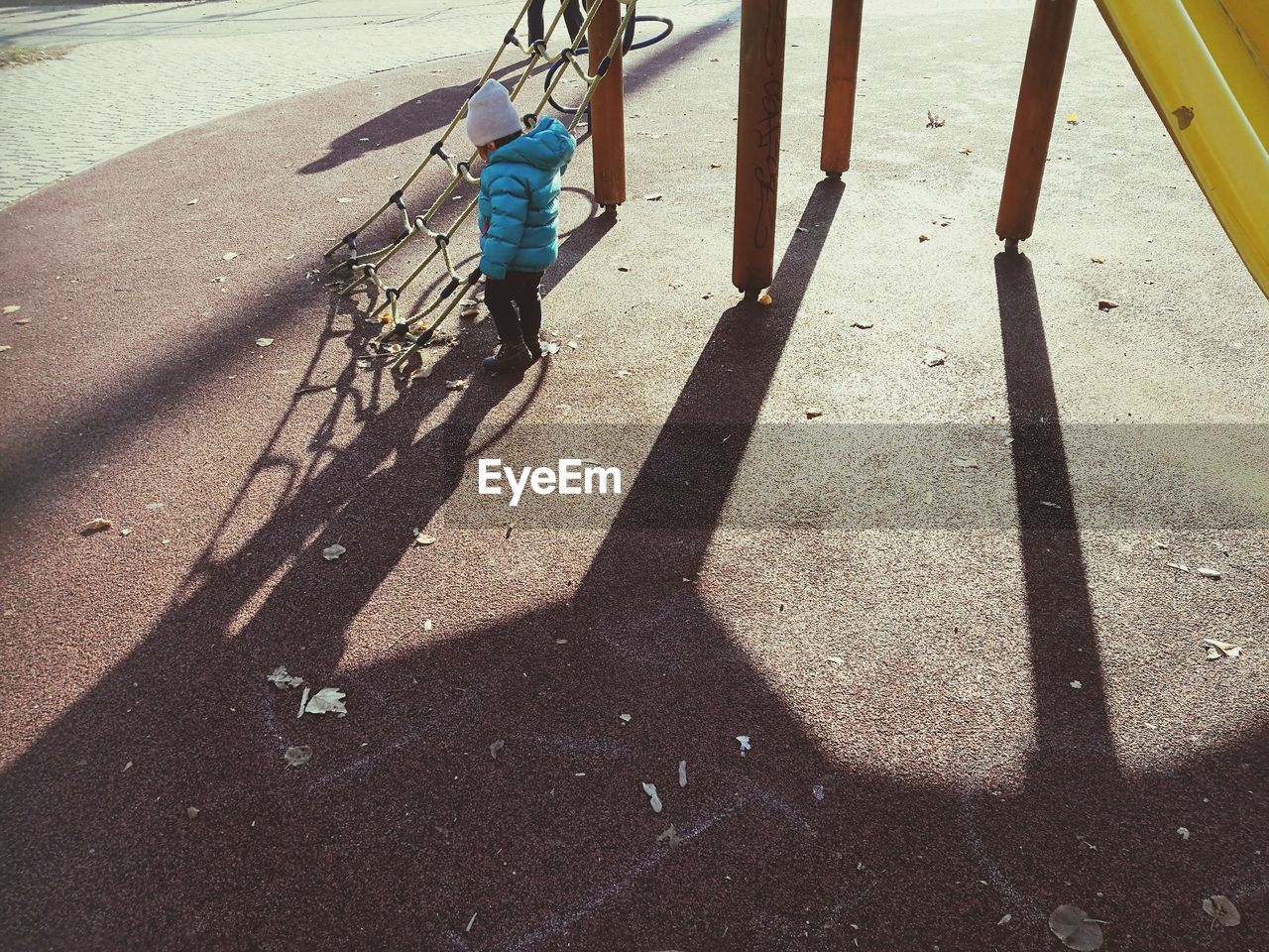 High angle view of boy standing by jungle gym at park