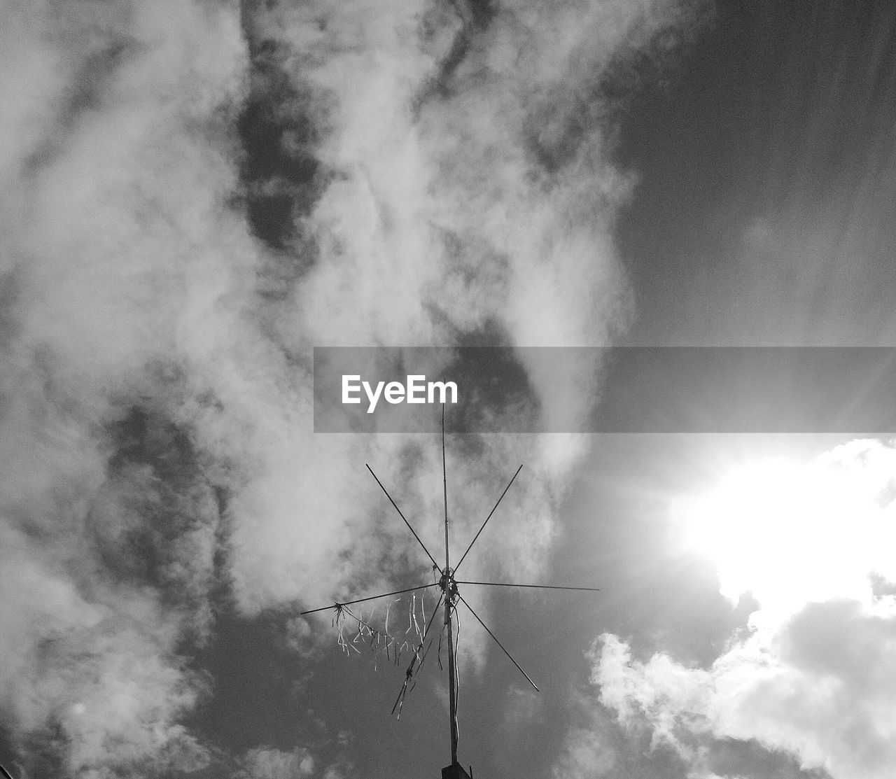 Low angle view of antenna against sky during sunny day