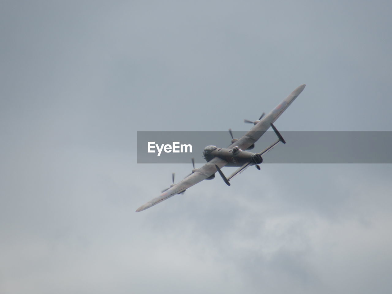 Low angle view of fighter plane flying in sky