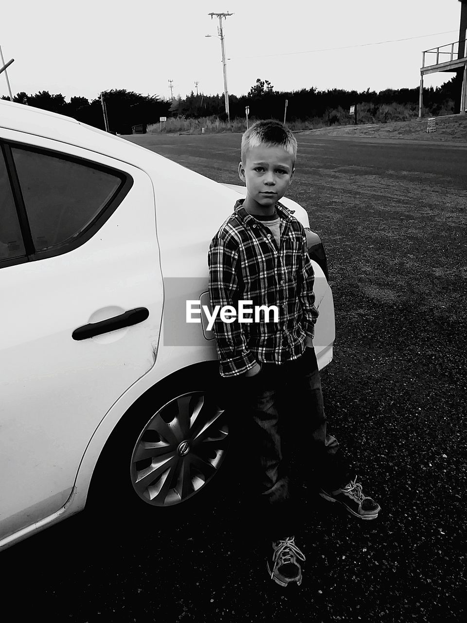 BOY STANDING WITH UMBRELLA