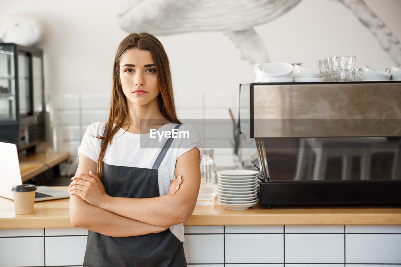 Portrait of young woman standing at home