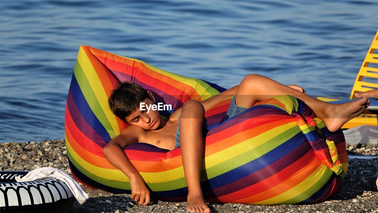 Boy lying on beach