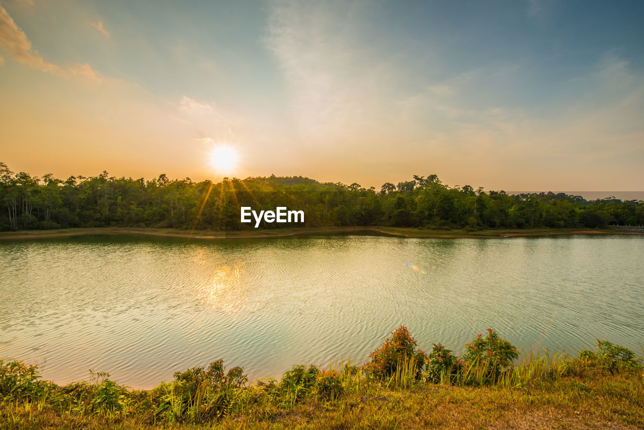 Scenic view of lake against sky during sunset