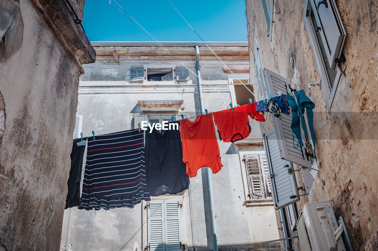 Low angle view of clothes drying on building