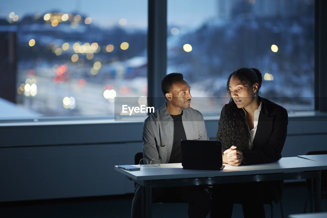 Colleagues working late in office