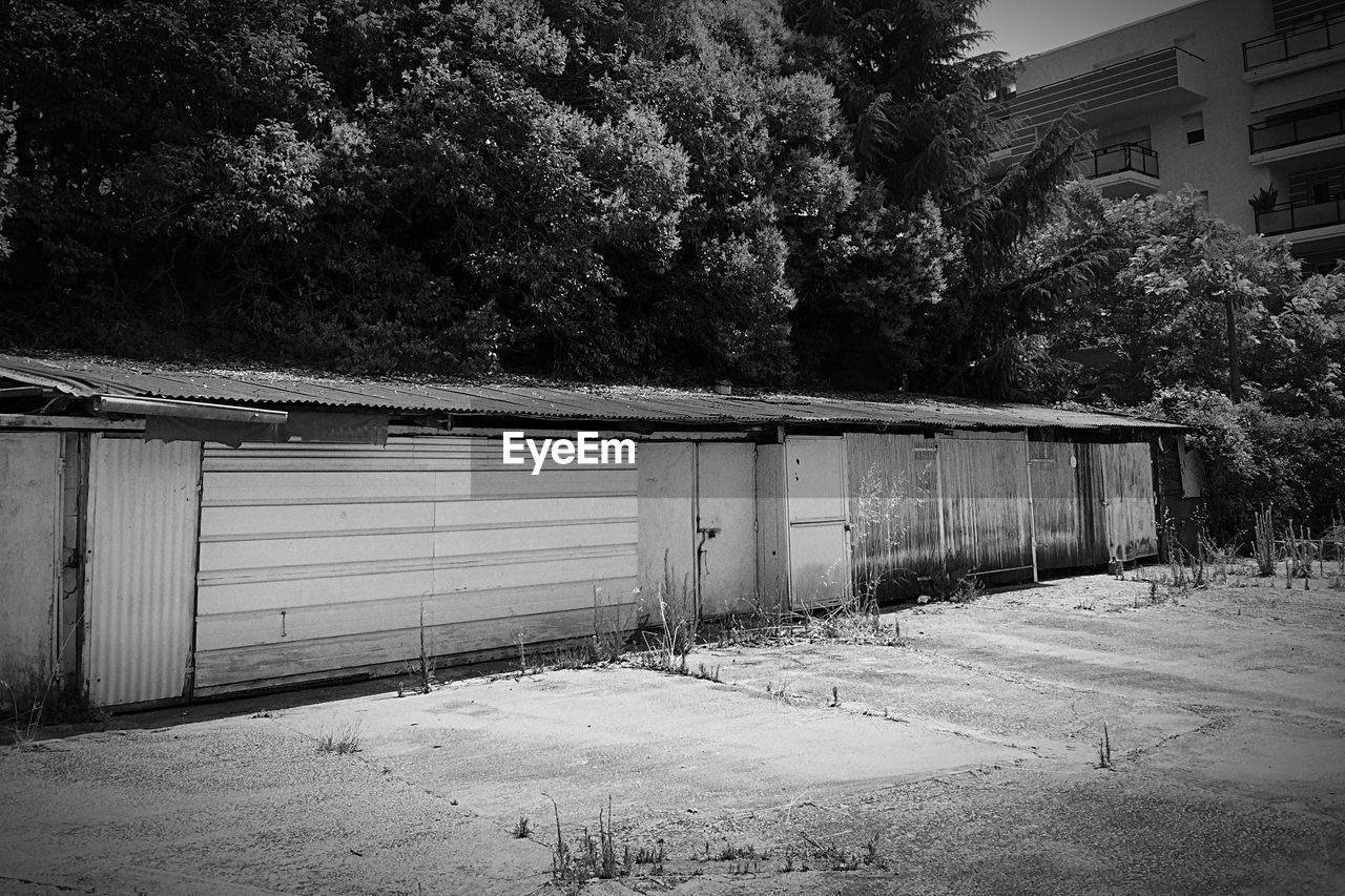 Huts by buildings and trees