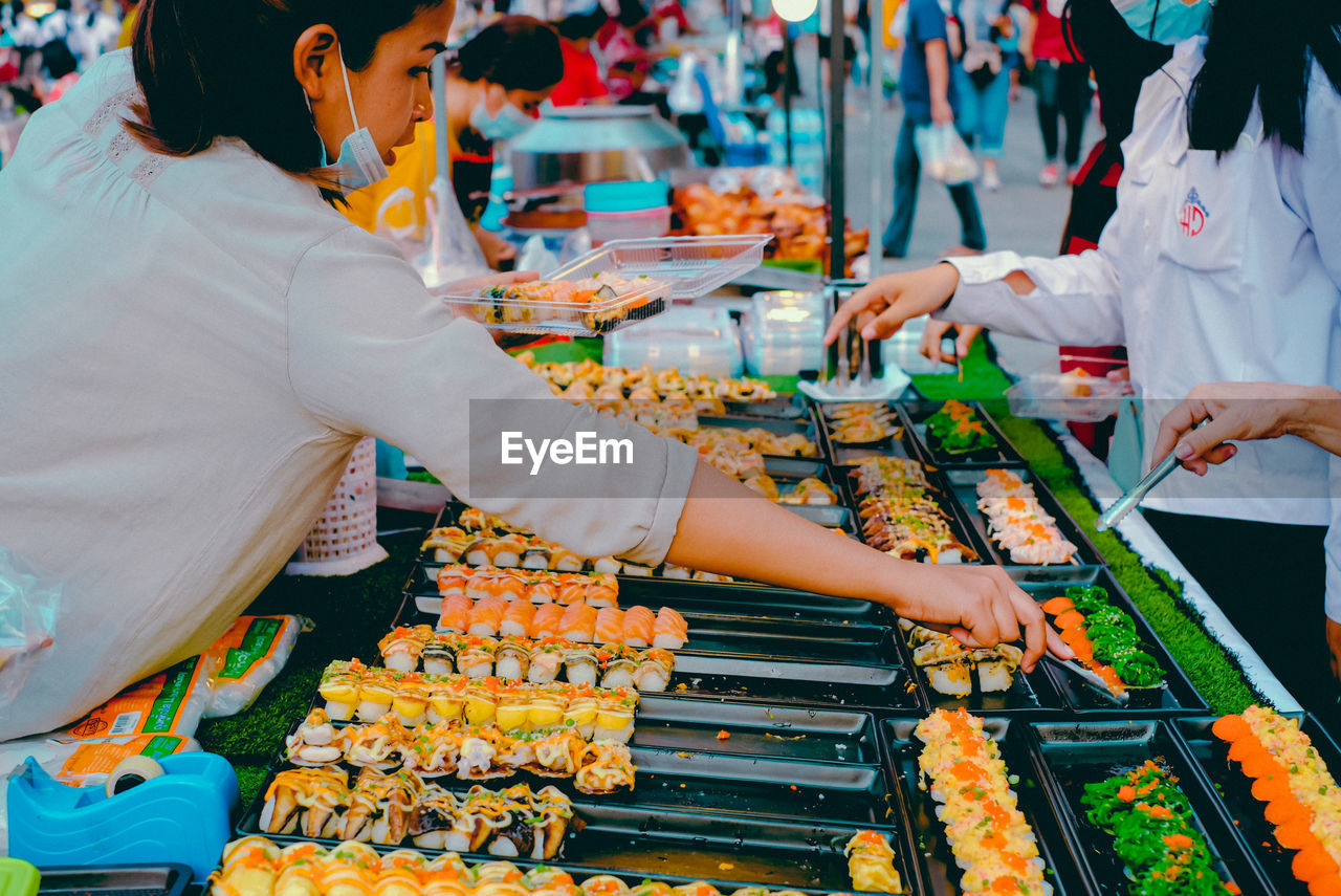 Group of people at market stall