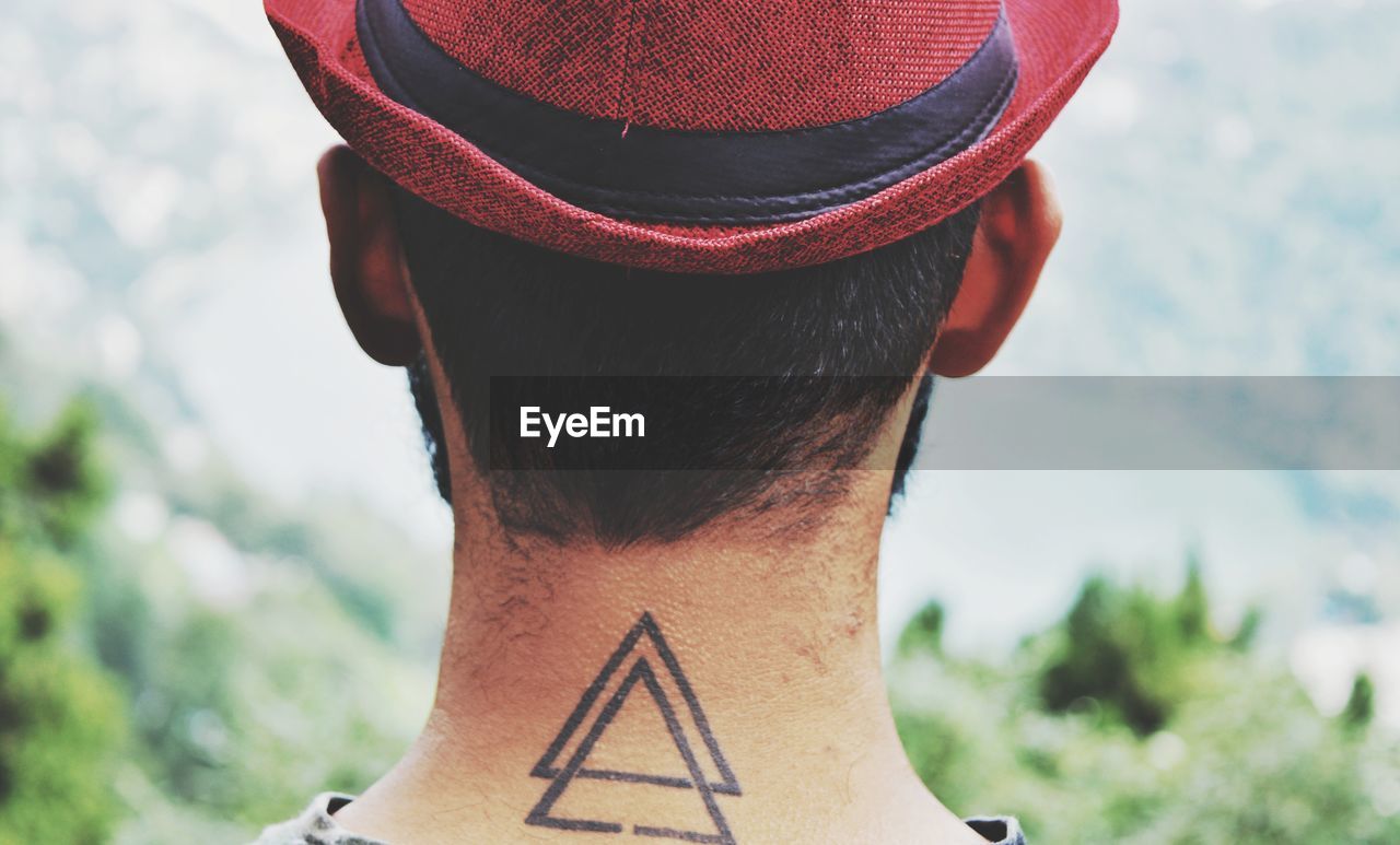 Rear view of man with tattoo on neck