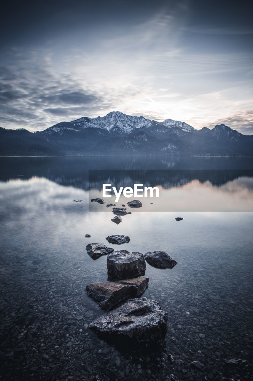 Scenic view of rocks in lake against sky