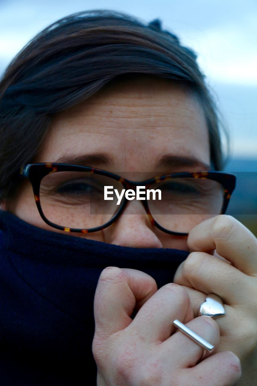 Close-up portrait of woman covering face with fabric