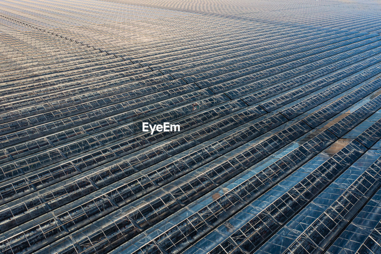 Full frame aerial view of rows of greenhouses in a food production plant