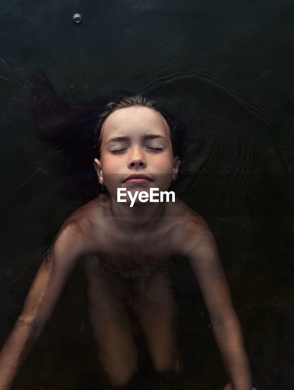 Portrait of young woman swimming in sea