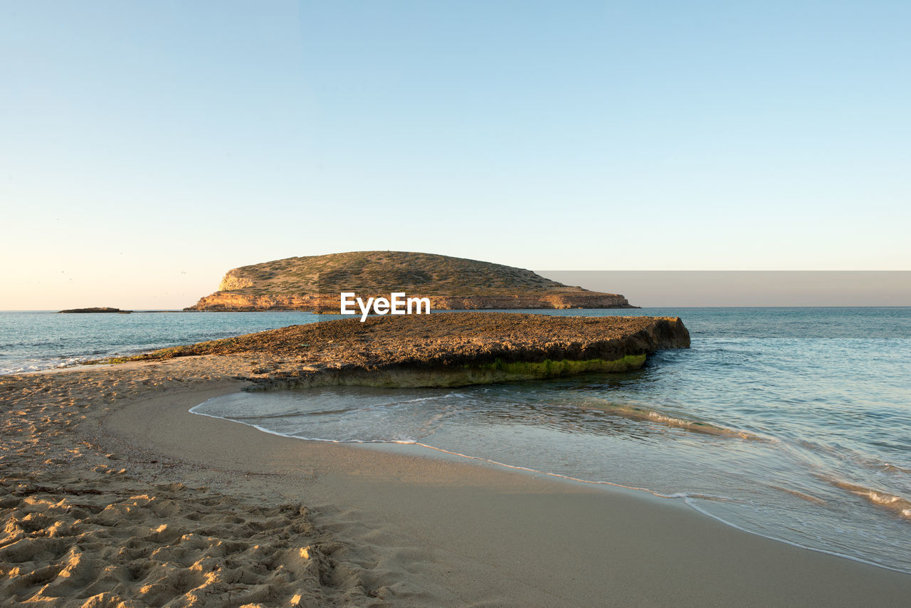 Scenic view of beach against clear sky