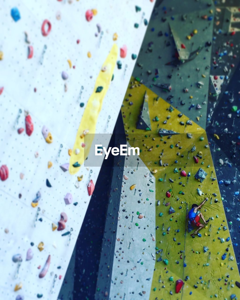 Low angle view of man bouldering on climbing wall