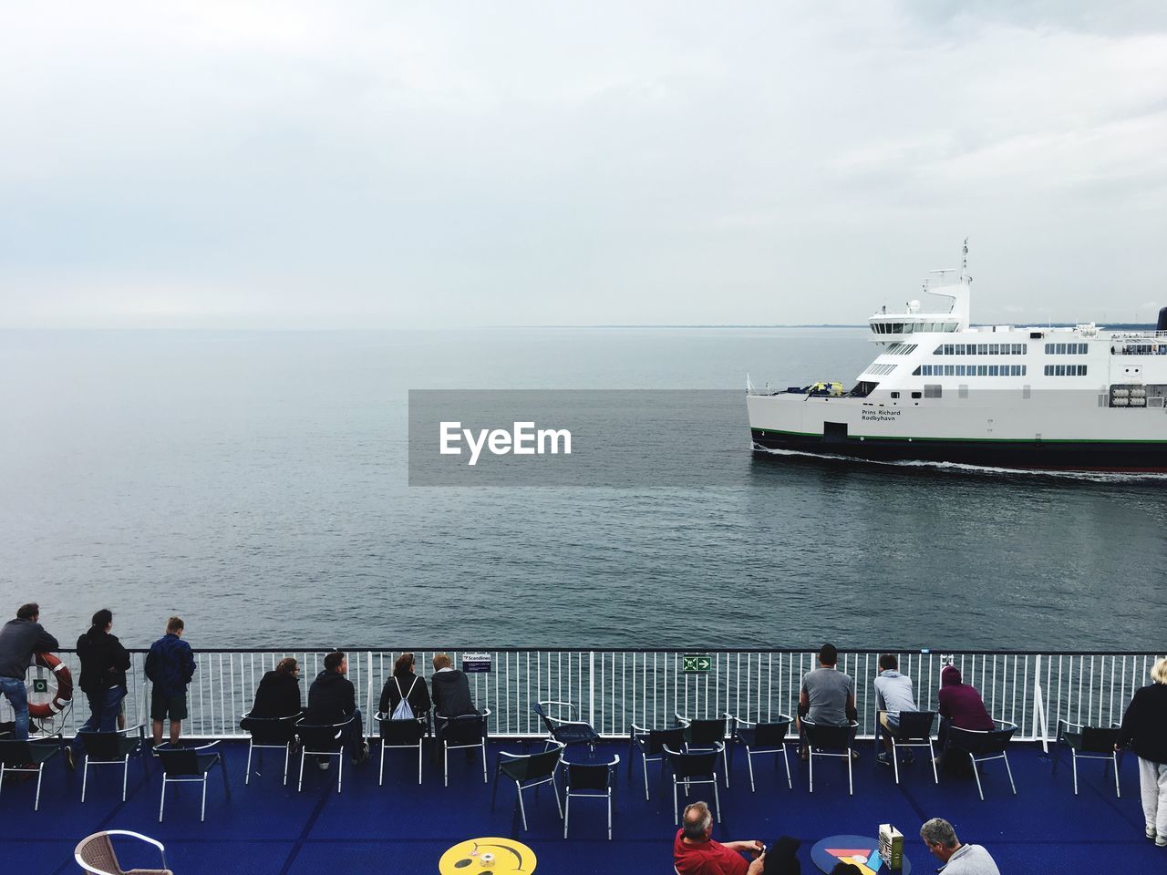 People at beach against sky
