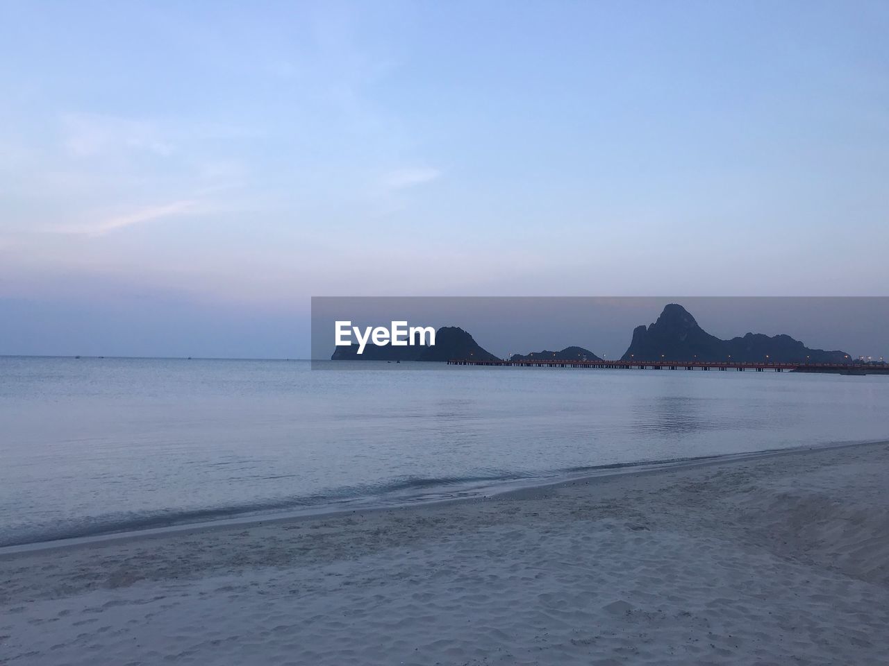 SCENIC VIEW OF BEACH AGAINST BLUE SKY