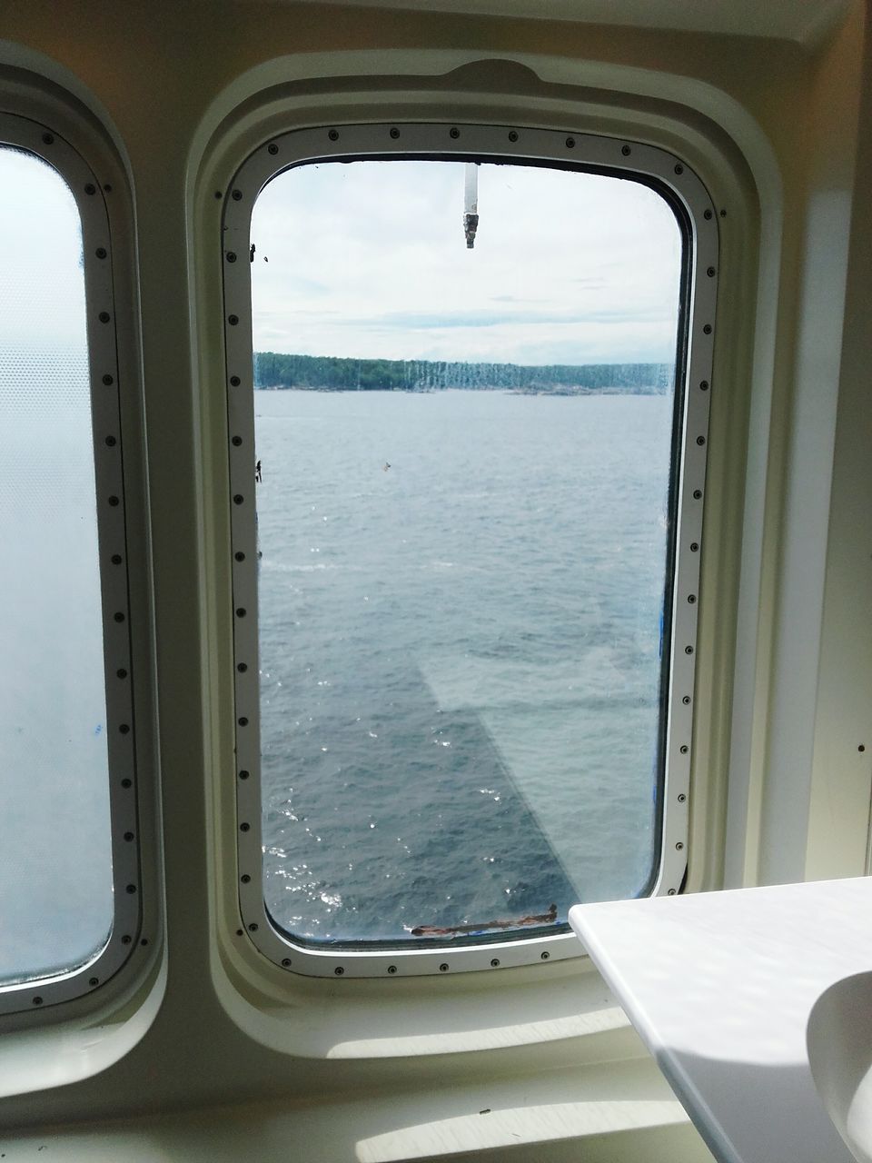 SEA SEEN THROUGH AIRPLANE WINDOW