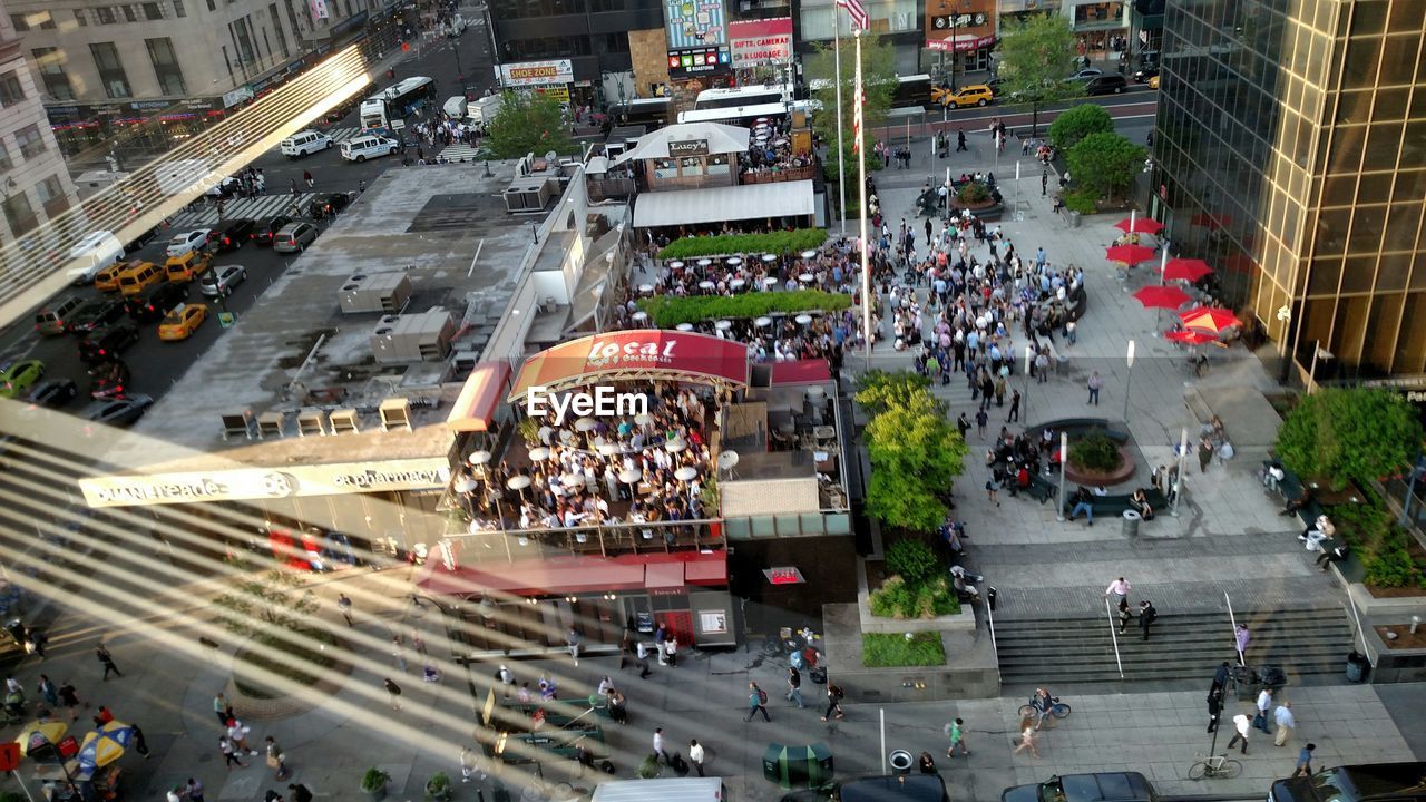 HIGH ANGLE VIEW OF PEOPLE WALKING ON STREET