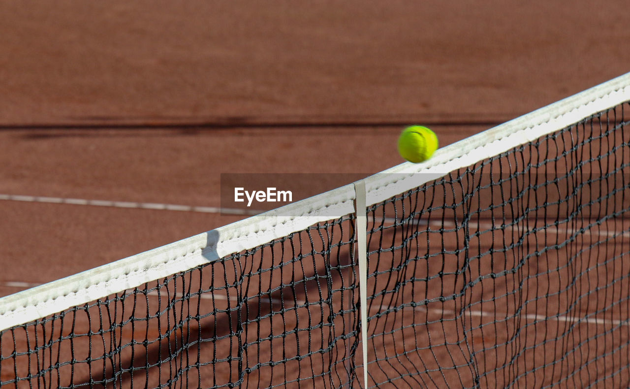 High angle view of ball over net at tennis court