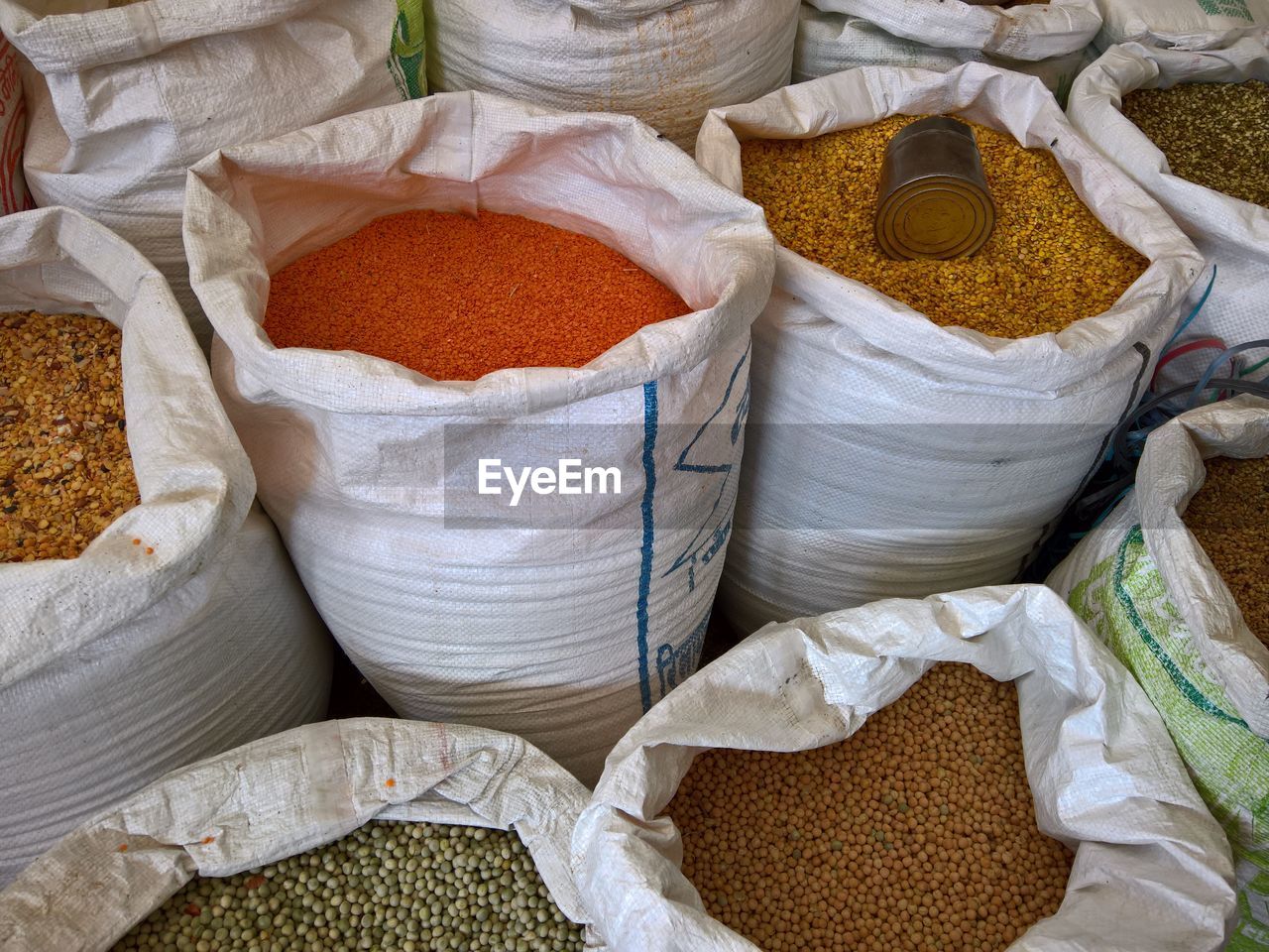 High angle view of multi colored lentils in sack at market