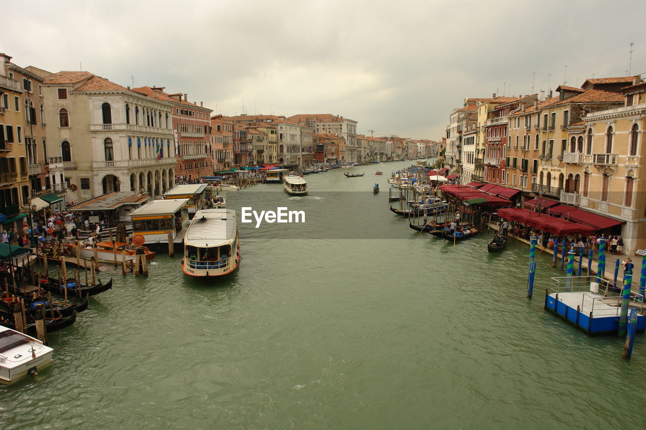 BOATS IN CANAL PASSING THROUGH BUILDINGS