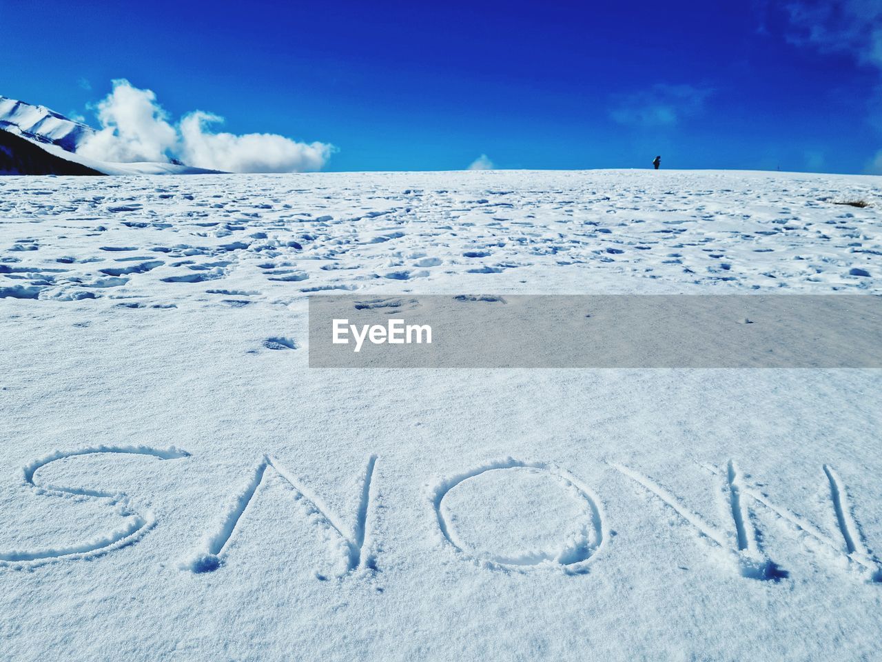 TEXT WRITTEN ON SNOW COVERED LAND AGAINST SKY