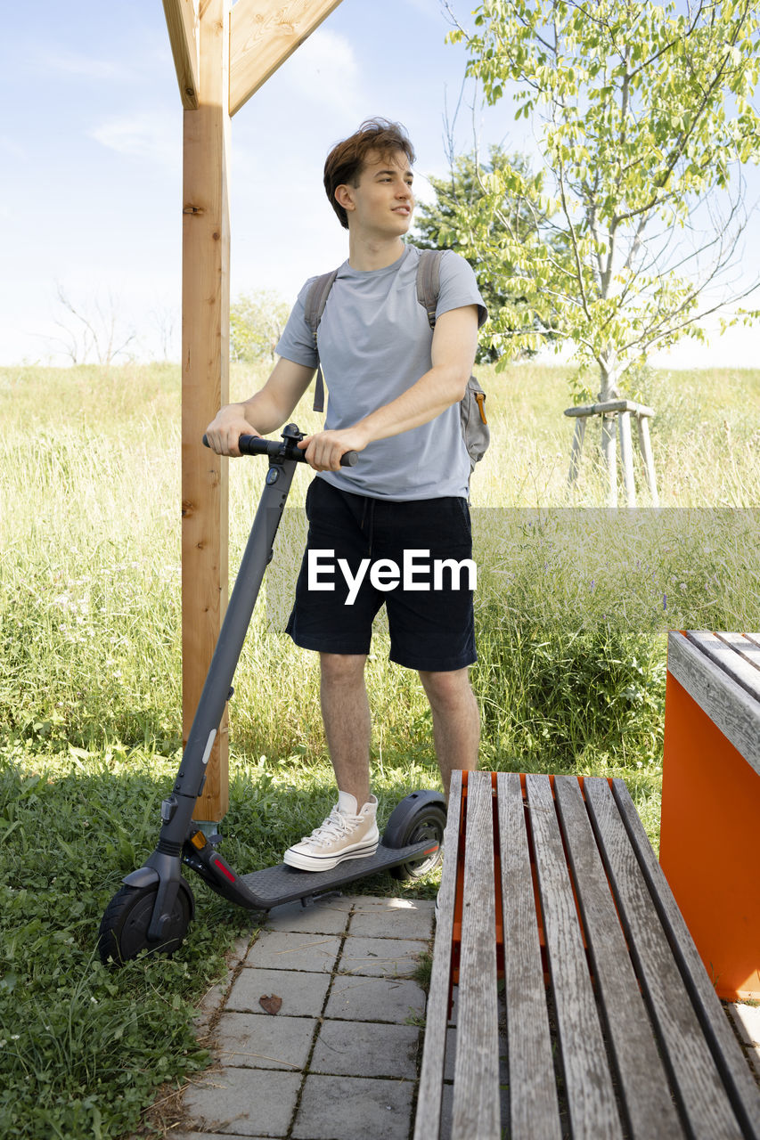 full length of man exercising on wooden bench