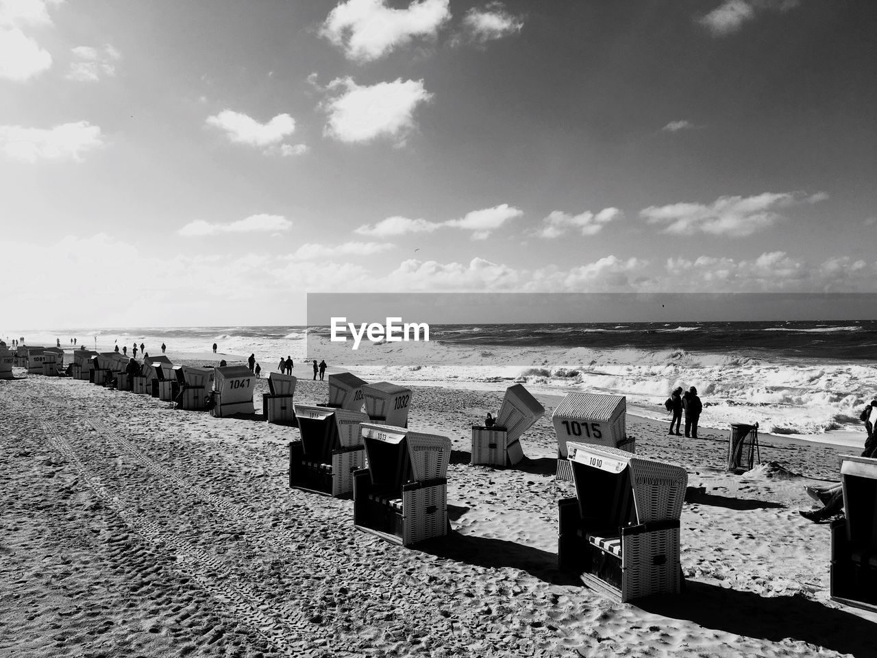 PANORAMIC VIEW OF PEOPLE ON BEACH AGAINST SKY