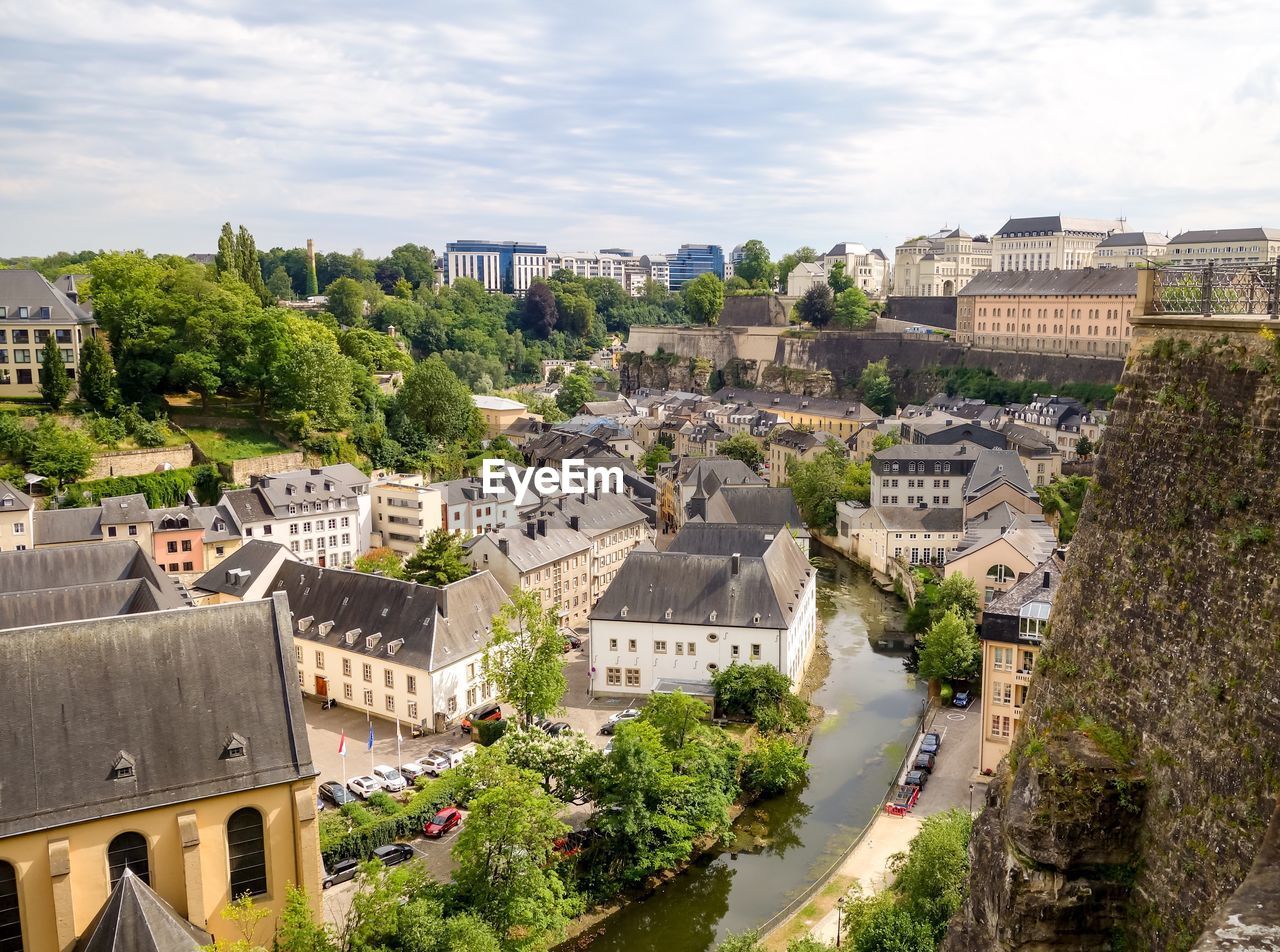 High angle view of buildings in town against sky