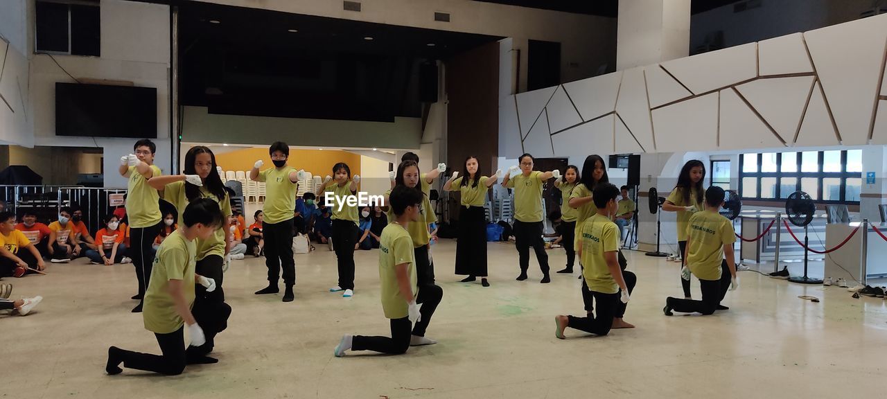 group of people, large group of people, crowd, indoors, full length, men, education, women, adult, student, young adult, learning, arts culture and entertainment, standing, female, school, performance, architecture, person