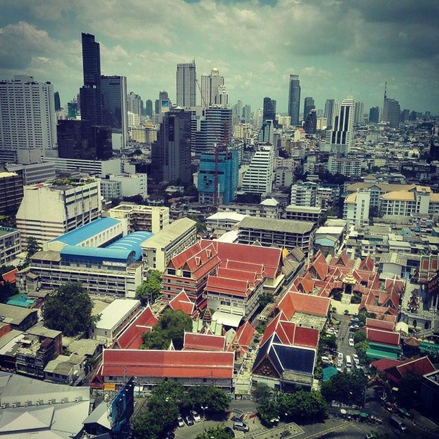 VIEW OF CITYSCAPE AGAINST CLOUDY SKY