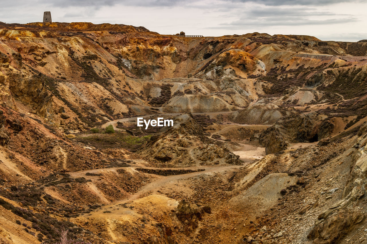 The orange and brown landscape of the disused parys mountain copper mine, anglesey, north wales.