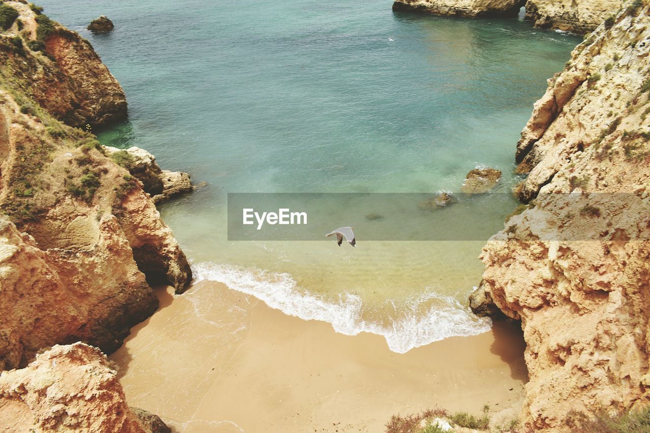 High angle view of rocks on sea shore