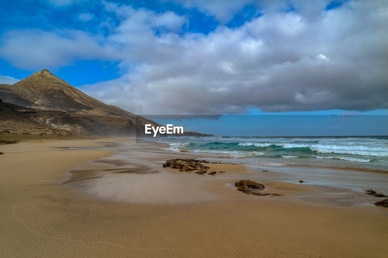 Scenic view of beach against sky