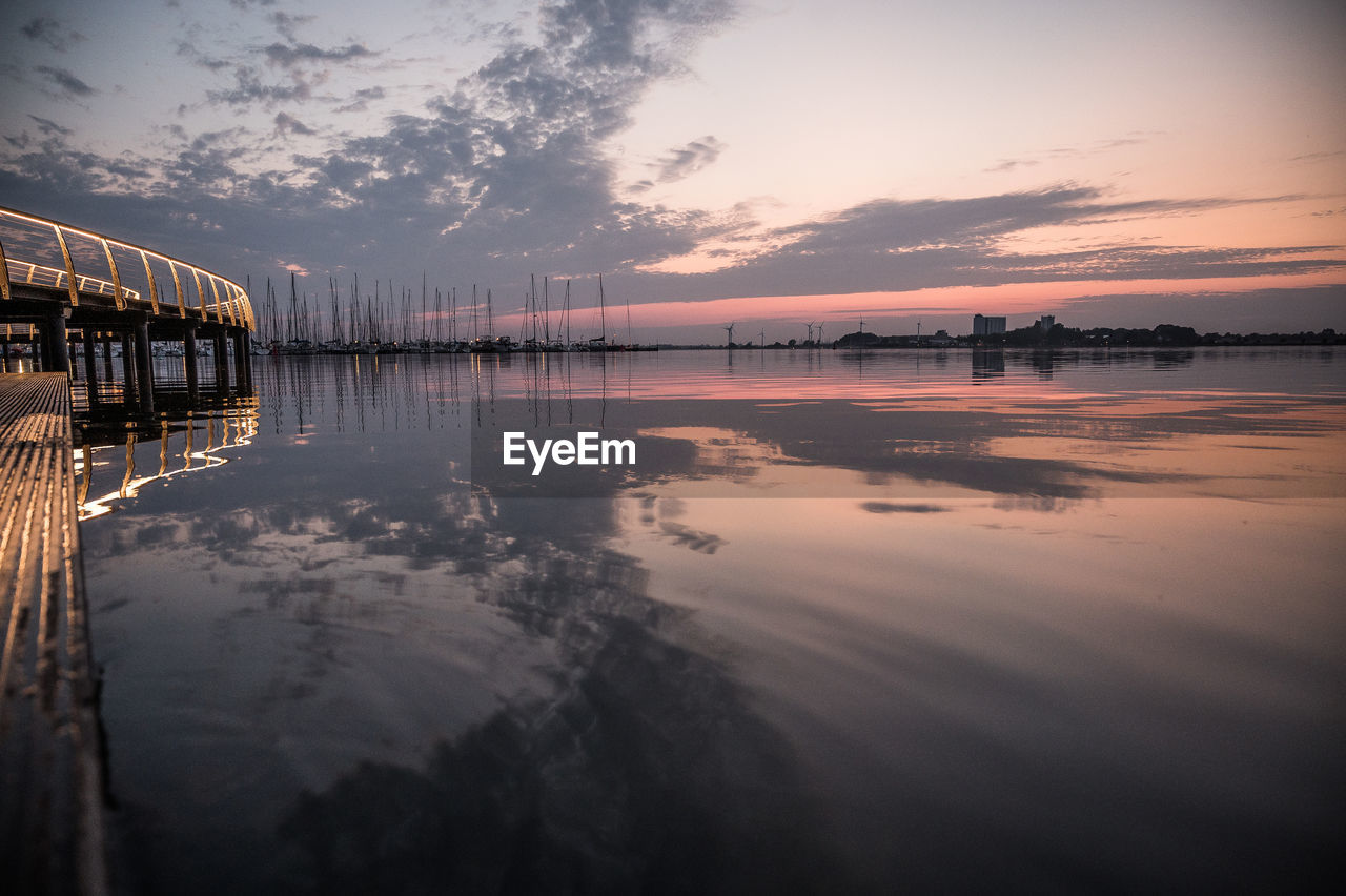 pier over sea against sky during sunset