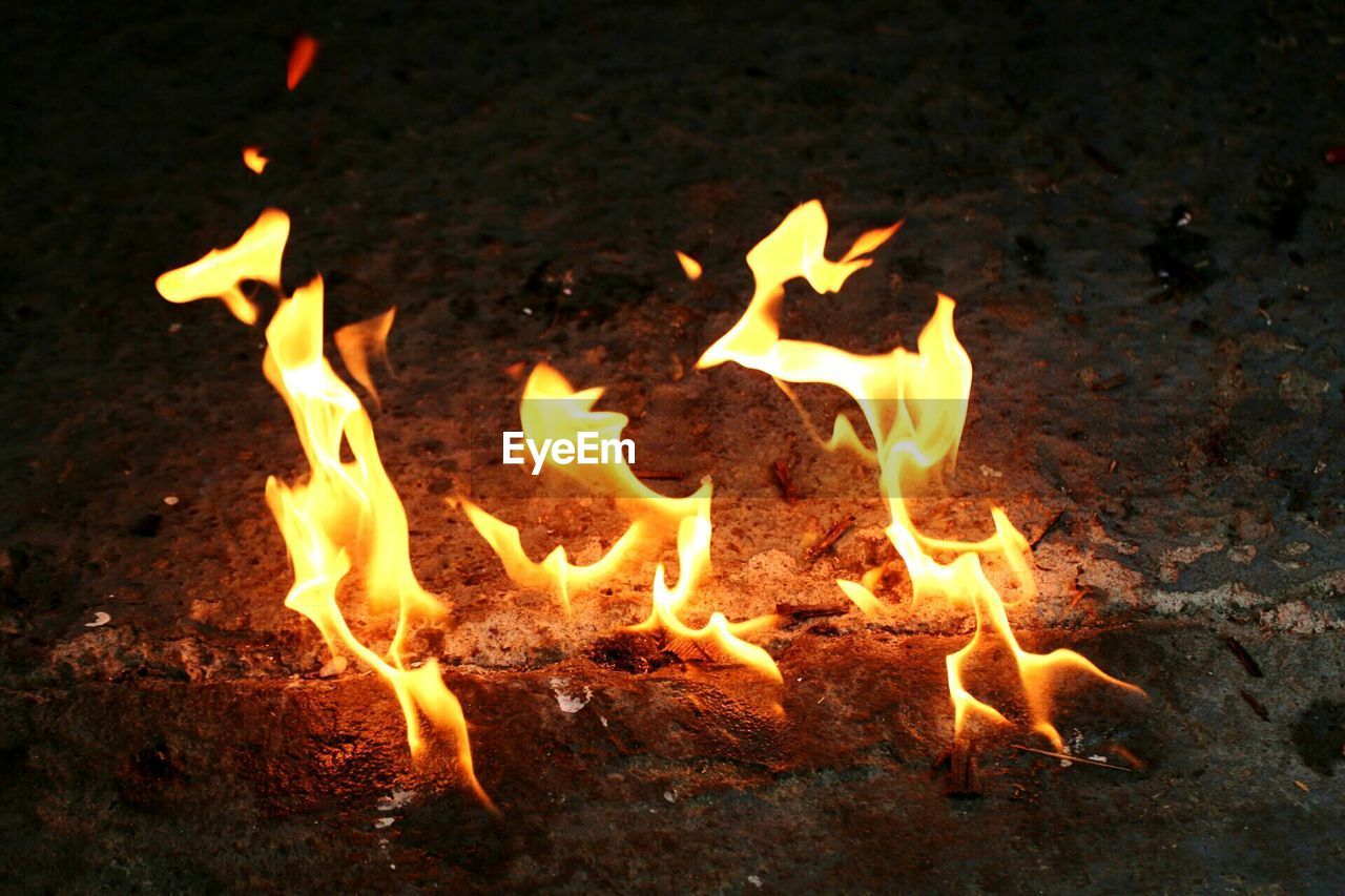 High angle view of fire on field at night