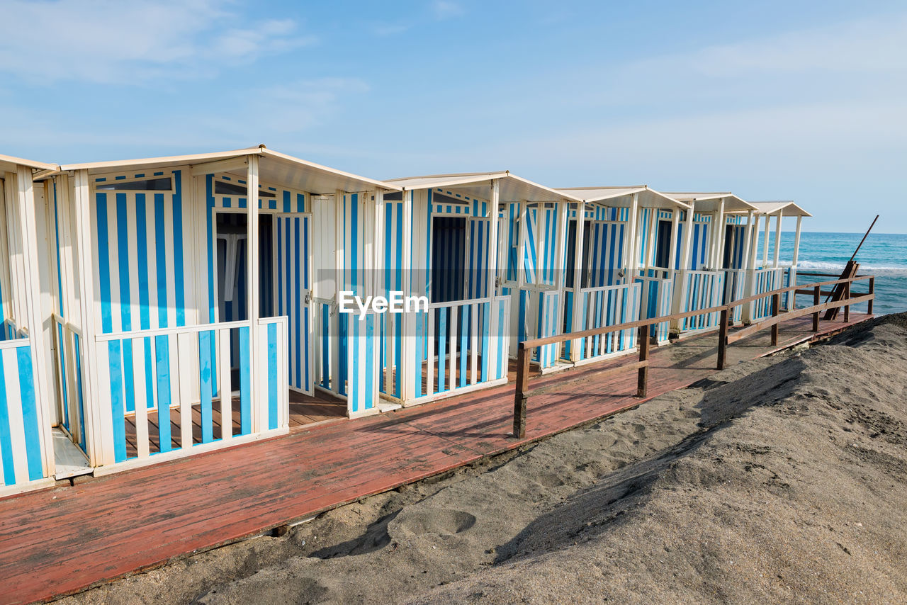 Built structure on beach against blue sky