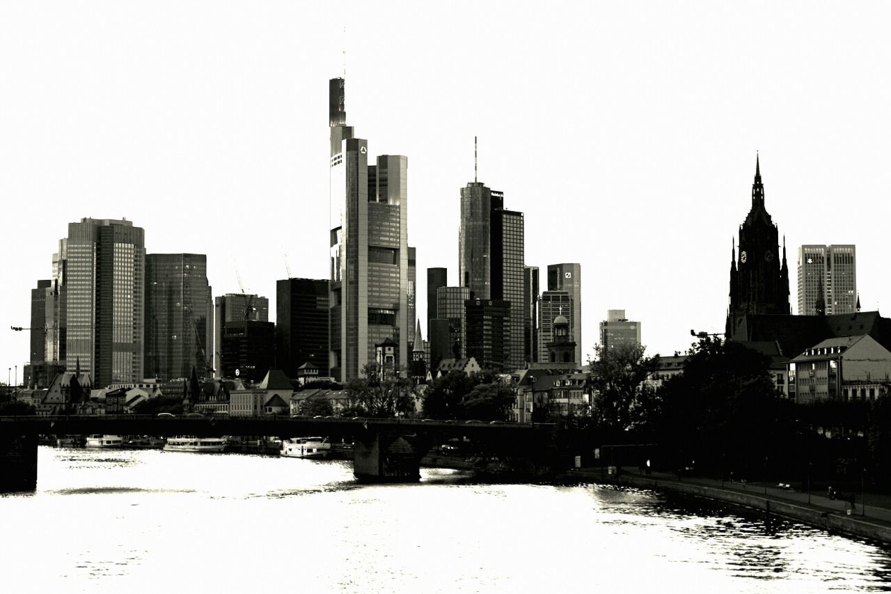 River with buildings against clear sky