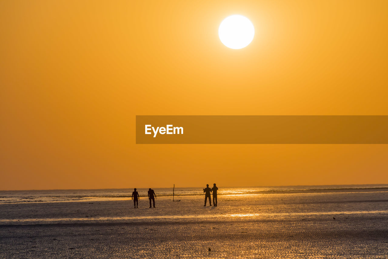 SILHOUETTE PEOPLE ON BEACH DURING SUNSET